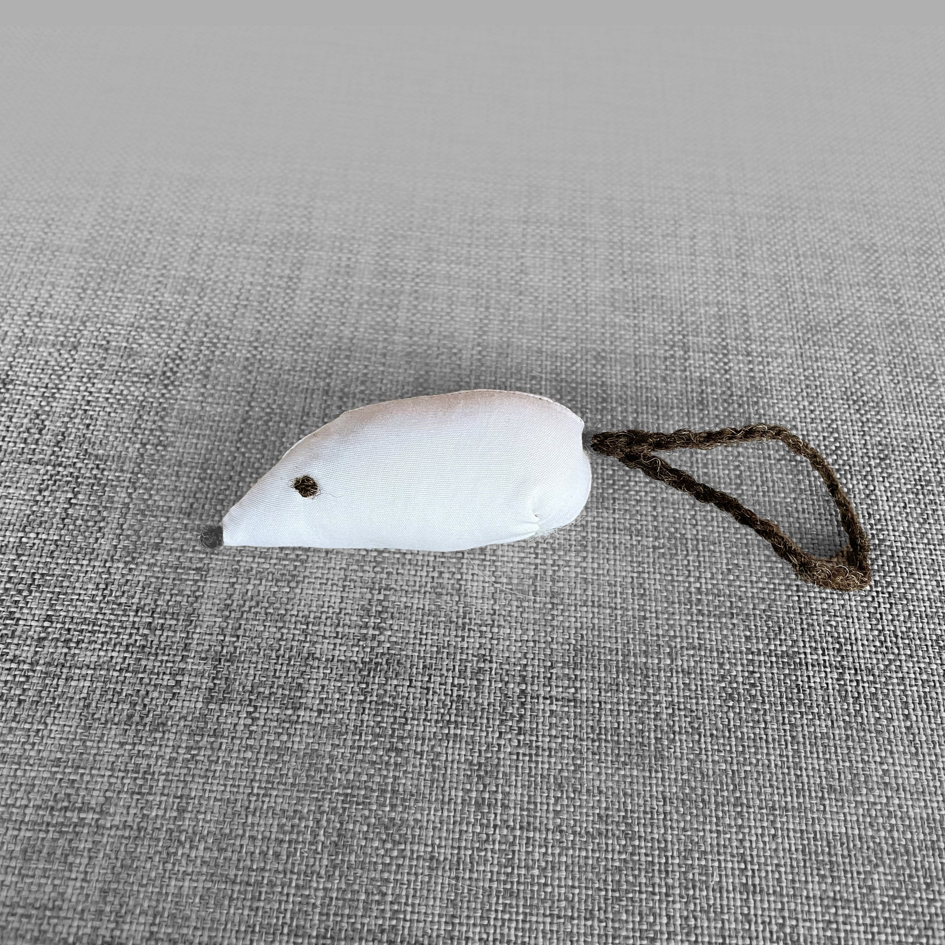Jouet pour chat en forme de souris en tissu blanc avec queue en corde tressee, vu de profil
